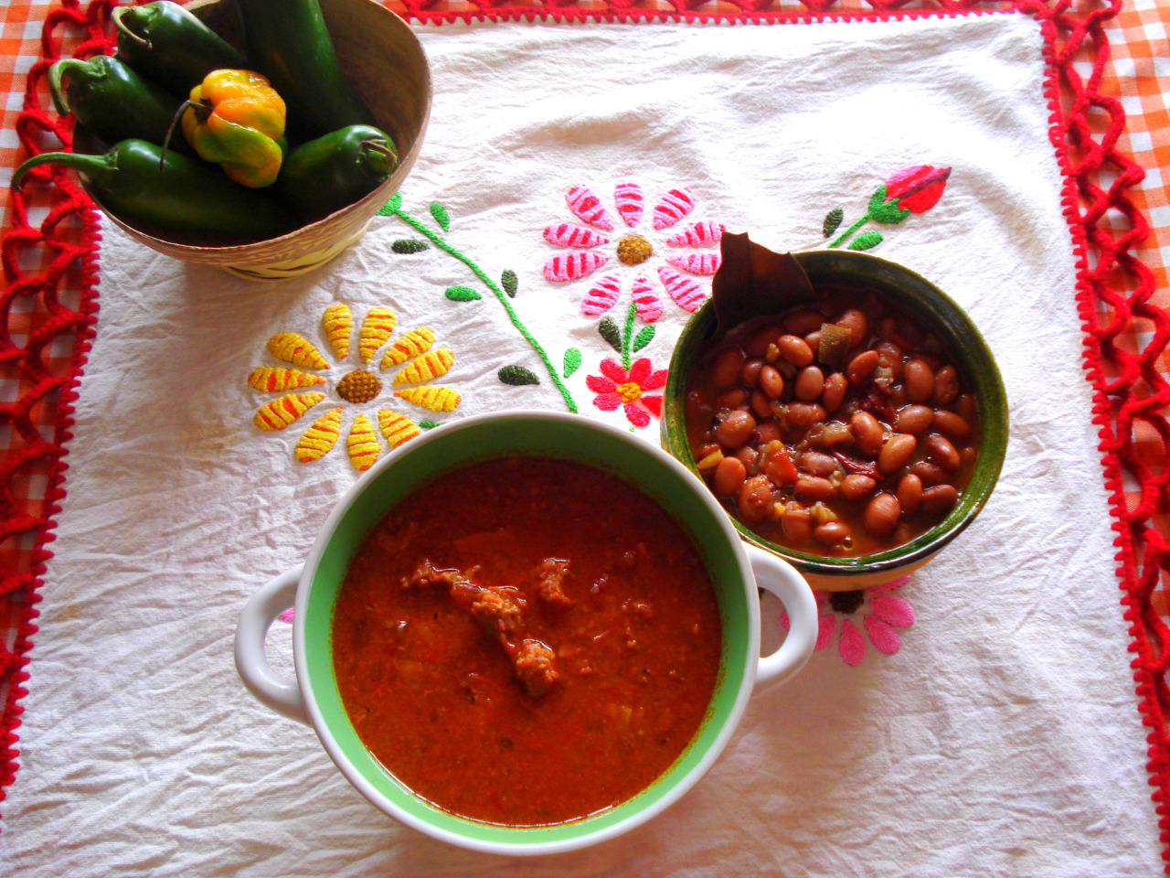 A bowl of Chile con Carne served with beans on the side.