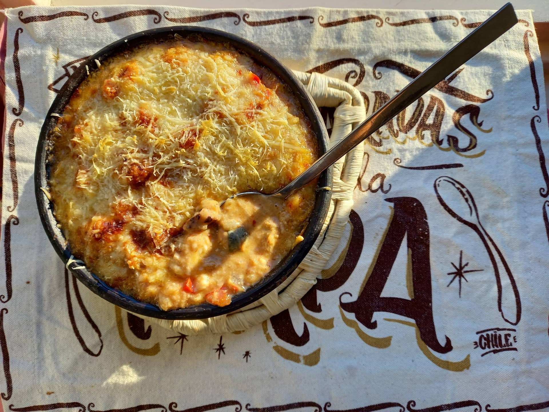 A portion of Chupe de Mariscos with a shrimp on top.