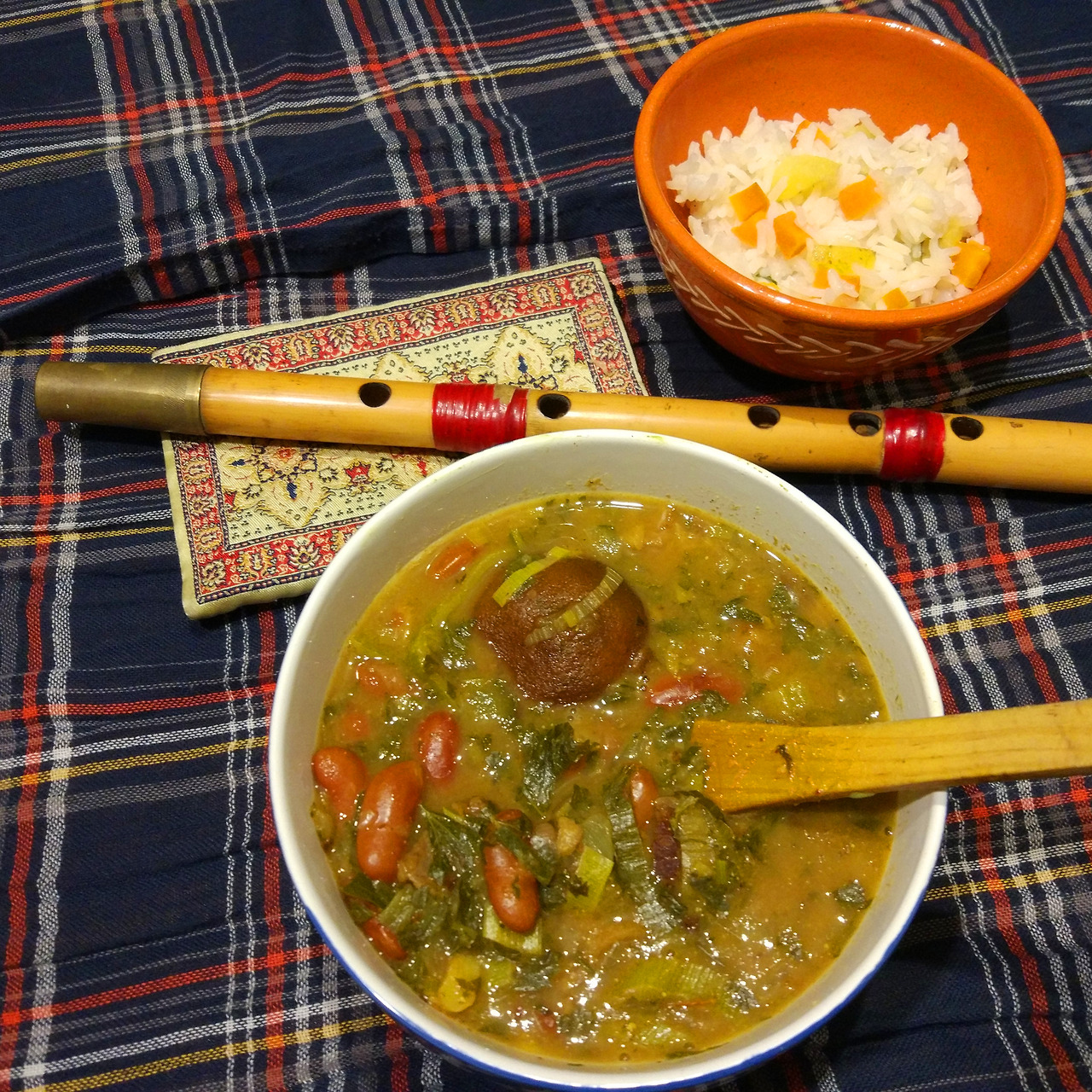 A bowl of Iranian herb stew with a limo amani (a dried lime) in it.