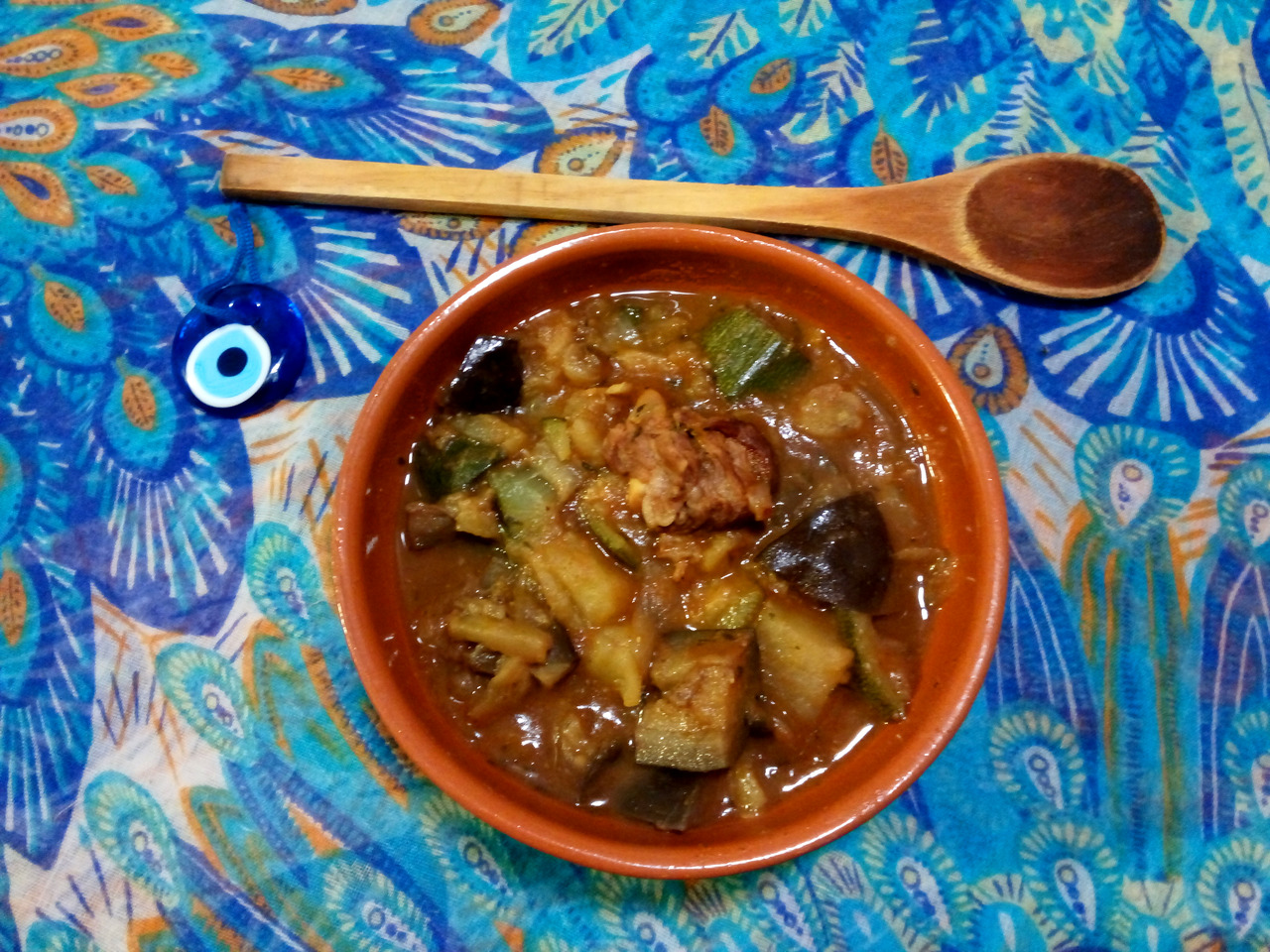 A bowl of kuzu güveç stew on a Turkish blue mantelpiece.