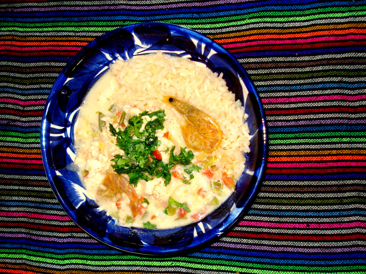 A bowl with pescado encocado and rice.