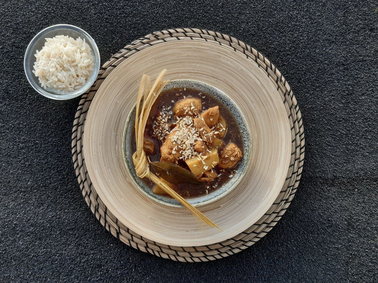 Semur ayam stew served in a bowl with a side of white rice.