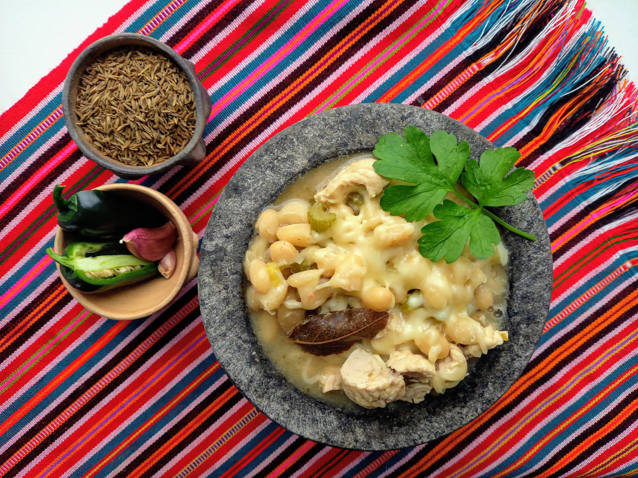 A stone bowl full of delicious white chili.